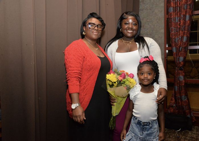A scholar and family celebrating at the 2025 ceremony